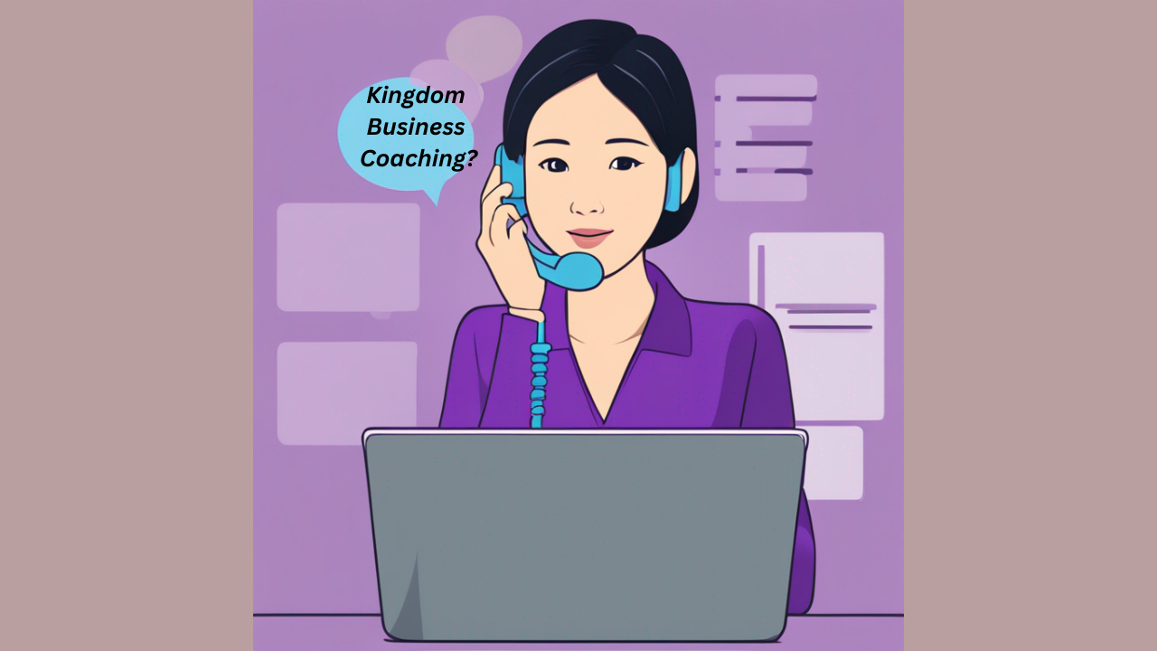 An Asian woman working on her laptop while speaking on the phone asked, "Kingdom Business Coaching?"